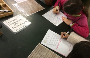 Children writing in Old English